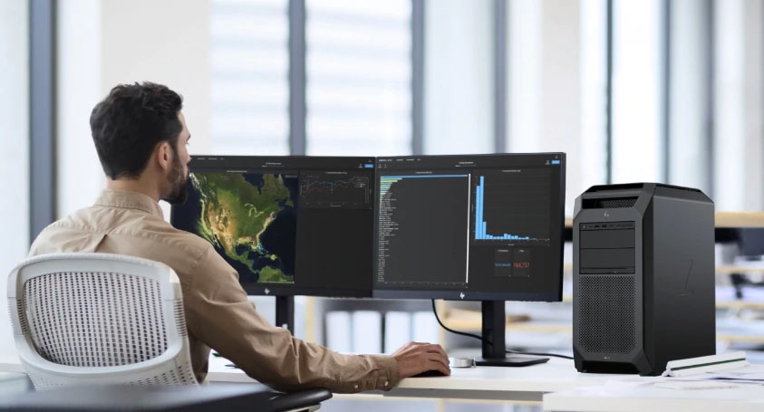 Analyst working across large data and systems screens